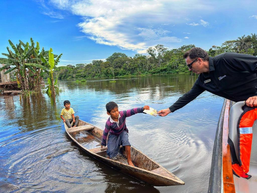Kike Calvo hand-delivering bilingual books in the Upper Amazon as part of The Adventures of Pili mission